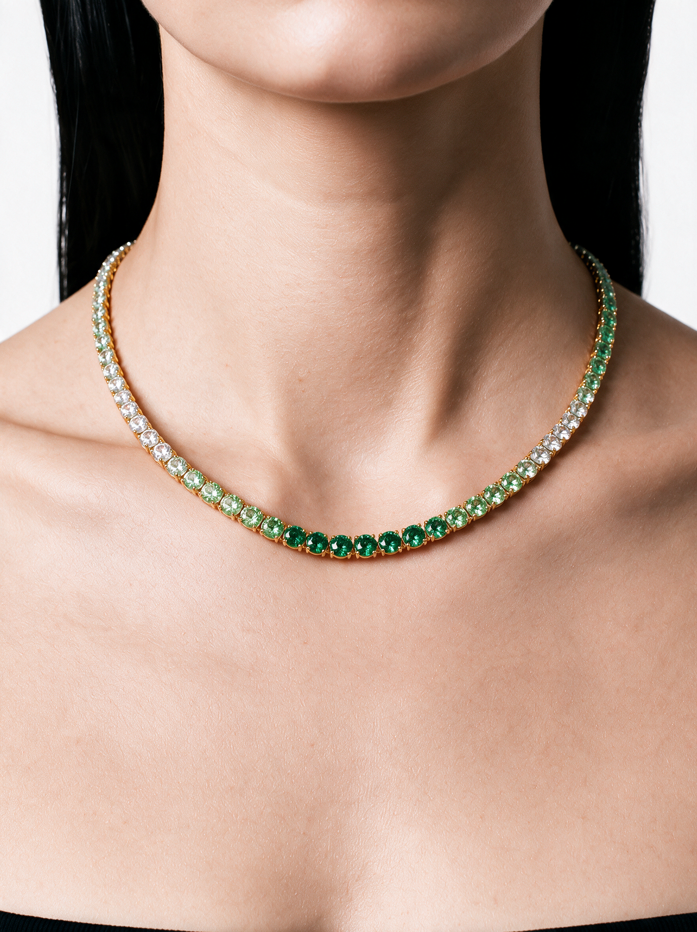 Gold Emerald Ombré Tennis Necklace worn on a woman's neck